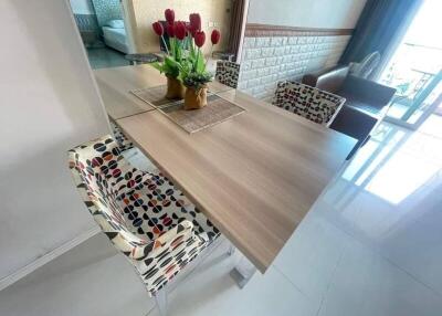 Dining area with a wooden table and colorful patterned chairs