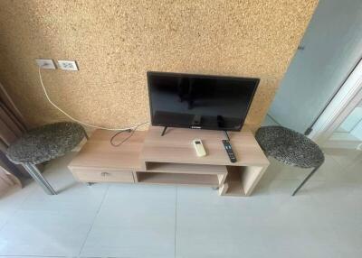 Television setup with small table and stools