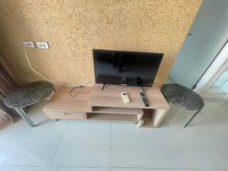 Television setup with small table and stools