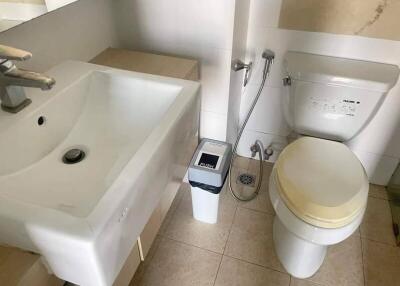 Modern bathroom with sink, toilet, and bidet spray