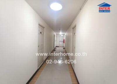 Apartment hallway with doors and overhead lighting