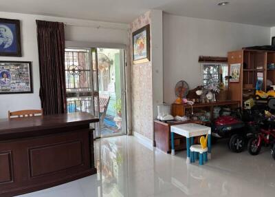 Spacious living room with large window and white tiled floors