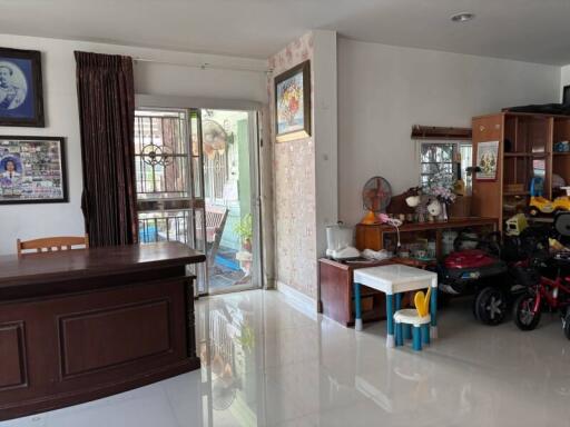 Spacious living room with large window and white tiled floors