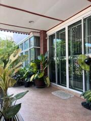 Spacious balcony with plants and glass sliding doors