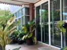 Spacious balcony with plants and glass sliding doors