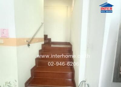 Staircase with wooden steps and a handrail