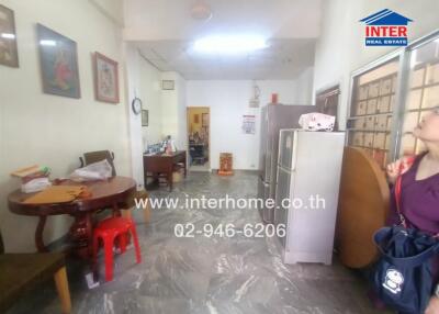 A well-lit kitchen and dining area with furniture and appliances