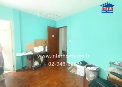 Bedroom with blue walls and parquet flooring