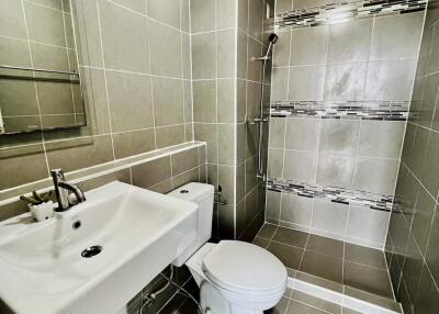 Modern bathroom with tiled walls and walk-in shower