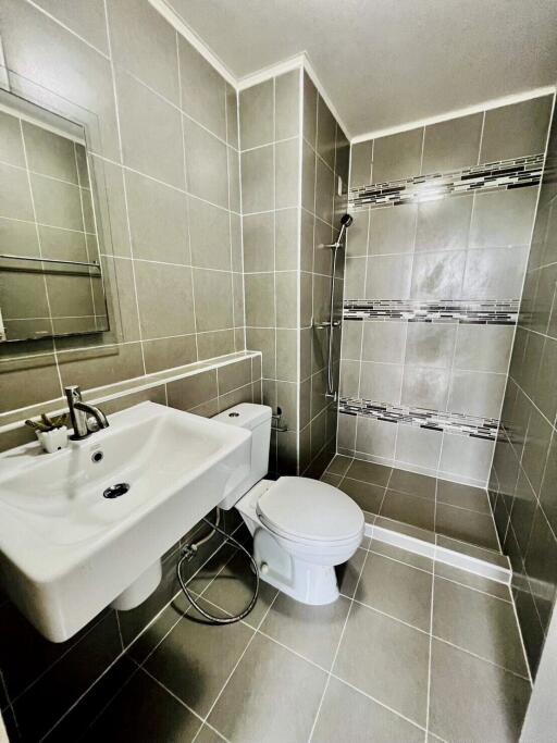 Modern bathroom with tiled walls and walk-in shower