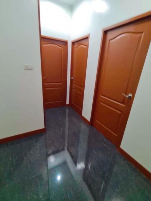 Hallway with three wooden doors