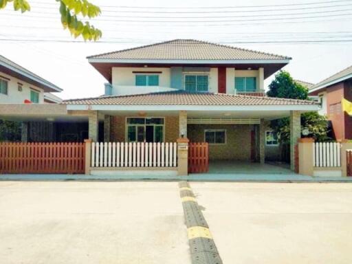 Front view of a two-story house with a fenced yard