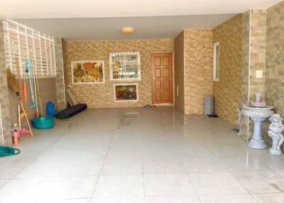 Covered outdoor space with tiled floor and decorative elements