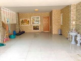 Covered outdoor space with tiled floor and decorative elements