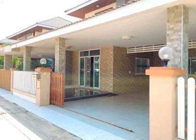 Outdoor picture of a residential building with a covered driveway or patio area.