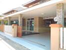 Outdoor picture of a residential building with a covered driveway or patio area.