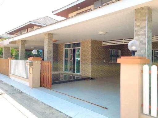 Outdoor picture of a residential building with a covered driveway or patio area.