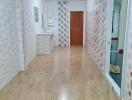 Bright hallway with wooden flooring and tile walls