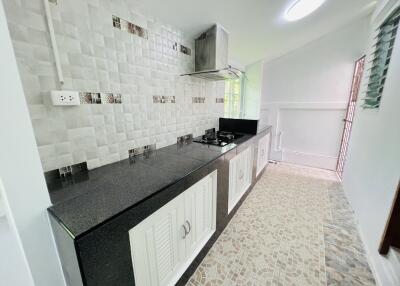 Modern kitchen with tiled backsplash, countertops, and built-in stove