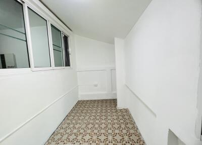 Simple room with patterned tile floor and white walls