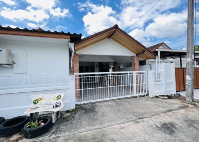 Front view of the property with covered car garage and gated entrance