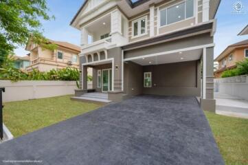 Front yard of a modern two-story house with driveway and garage