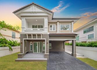 Front view of a modern two-story house with a large driveway