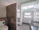 Modern bathroom with tiled walls and large windows