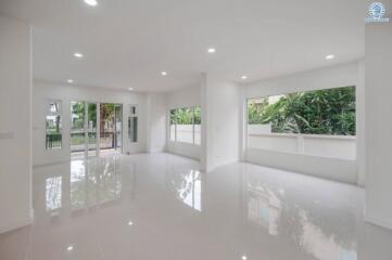 Spacious main living area with large windows and glossy tile flooring