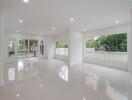 Spacious main living area with large windows and glossy tile flooring