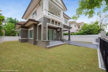 Modern two-story house with spacious lawn and driveway