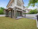 Modern two-story house with spacious lawn and driveway