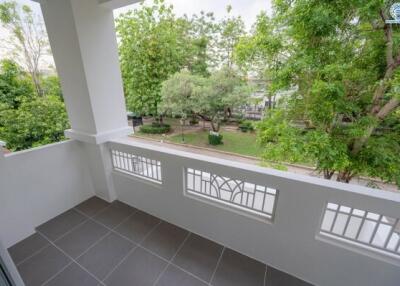 Balcony with a view of a green, tree-filled outdoor space