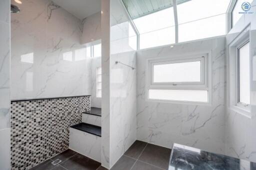 Modern bathroom with marble walls and mosaic tiles