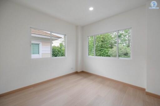 Bright and spacious empty bedroom with large windows