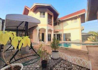 Exterior view of a house with a gazebo and pool