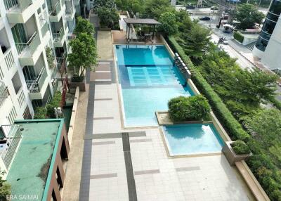 Apartment building with a swimming pool and greenery