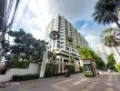 High-rise residential building with lush greenery and secure entrance