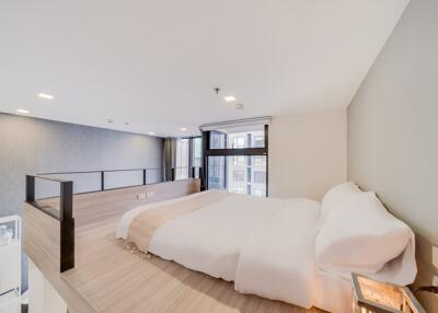 Loft bedroom with a large bed and natural lighting