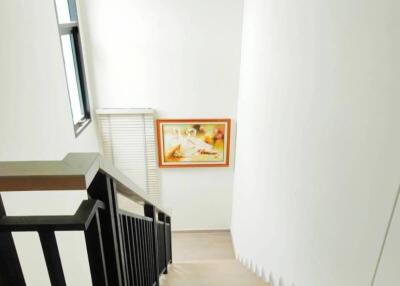 Bright stairwell with a window and artwork