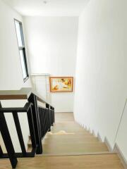 Bright stairwell with a window and artwork