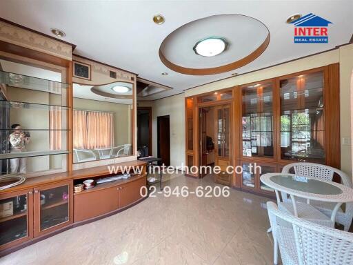 Spacious living room with built-in shelving and dining area