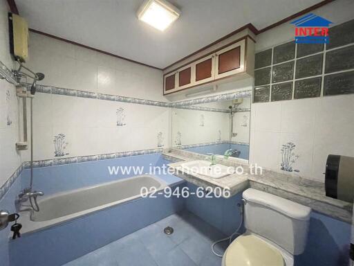 Bathroom with bathtub, sink, and toilet