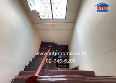 Interior staircase with wooden steps and handrail