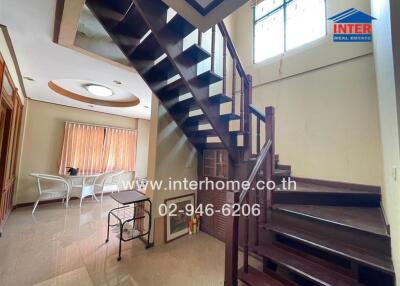 Living area with staircase and dining table
