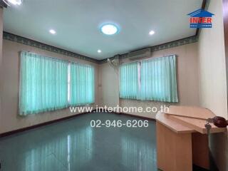 Living room with tiled flooring and large windows with curtains