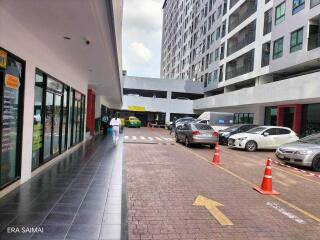 Outside view of a residential/commercial building complex with parking area