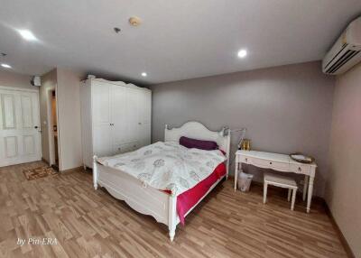 Spacious bedroom with double bed and furniture