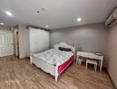 Spacious bedroom with double bed and furniture