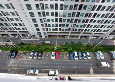 View of a modern residential building and its parking lot